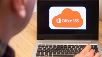 Office 365 is used by a man on the laptop. Microsoft customer used computer software. New product is tested by IT specialist. San Francisco, February 2020